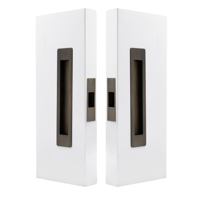 Windsor LUME sliding door flush pull passage set with two orange flush pulls on a door, modern hardware for sliding doors.