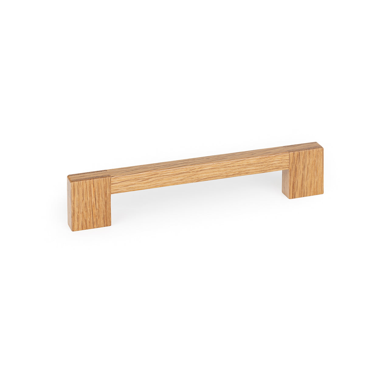 Momo HAKO timber cabinet pull handle in oak finish, sleek and modern design, mounted on a cabinet door.