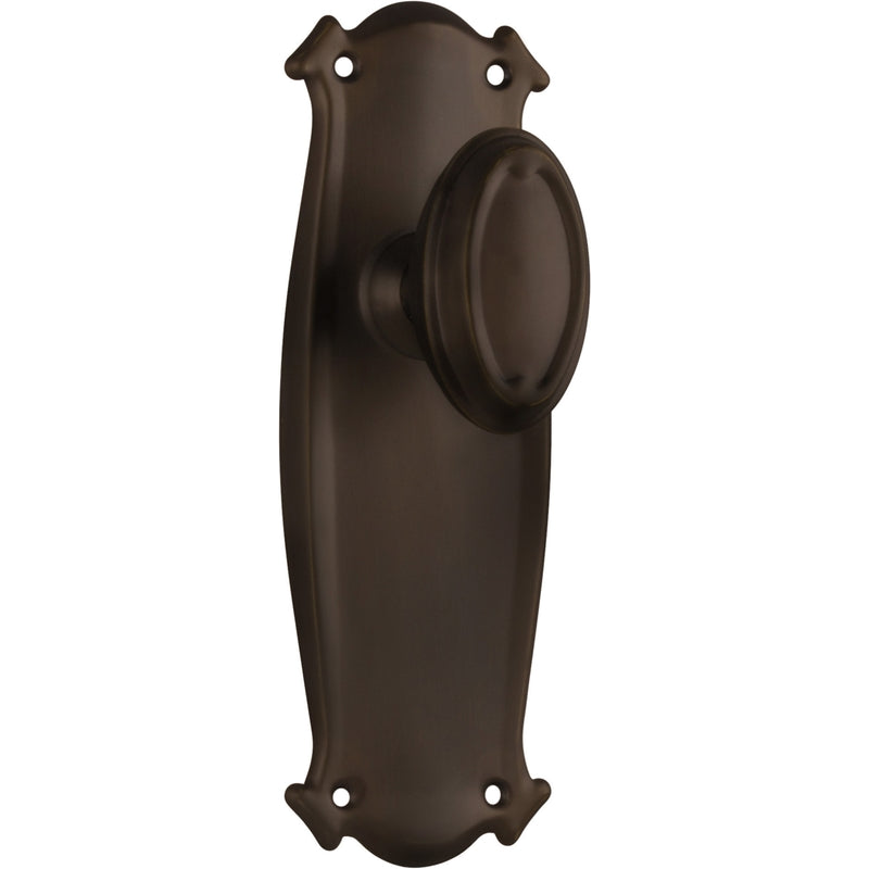 Pair of Tradco Bungalow Knobs on long backplates, showing vintage-style brass door hardware with ornate detailing.