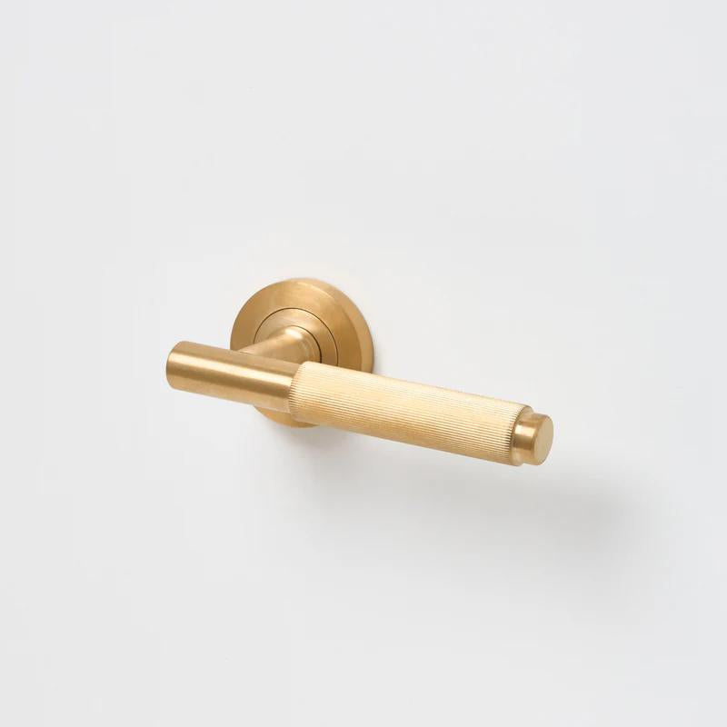 Lo & Co Linear Knurled Lever handle in brushed metal finish, close-up view showing textured grip and sleek design.