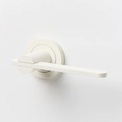 Lo & Co Intersect Lever door handle in polished metal with a sleek, modern design, mounted on a door.