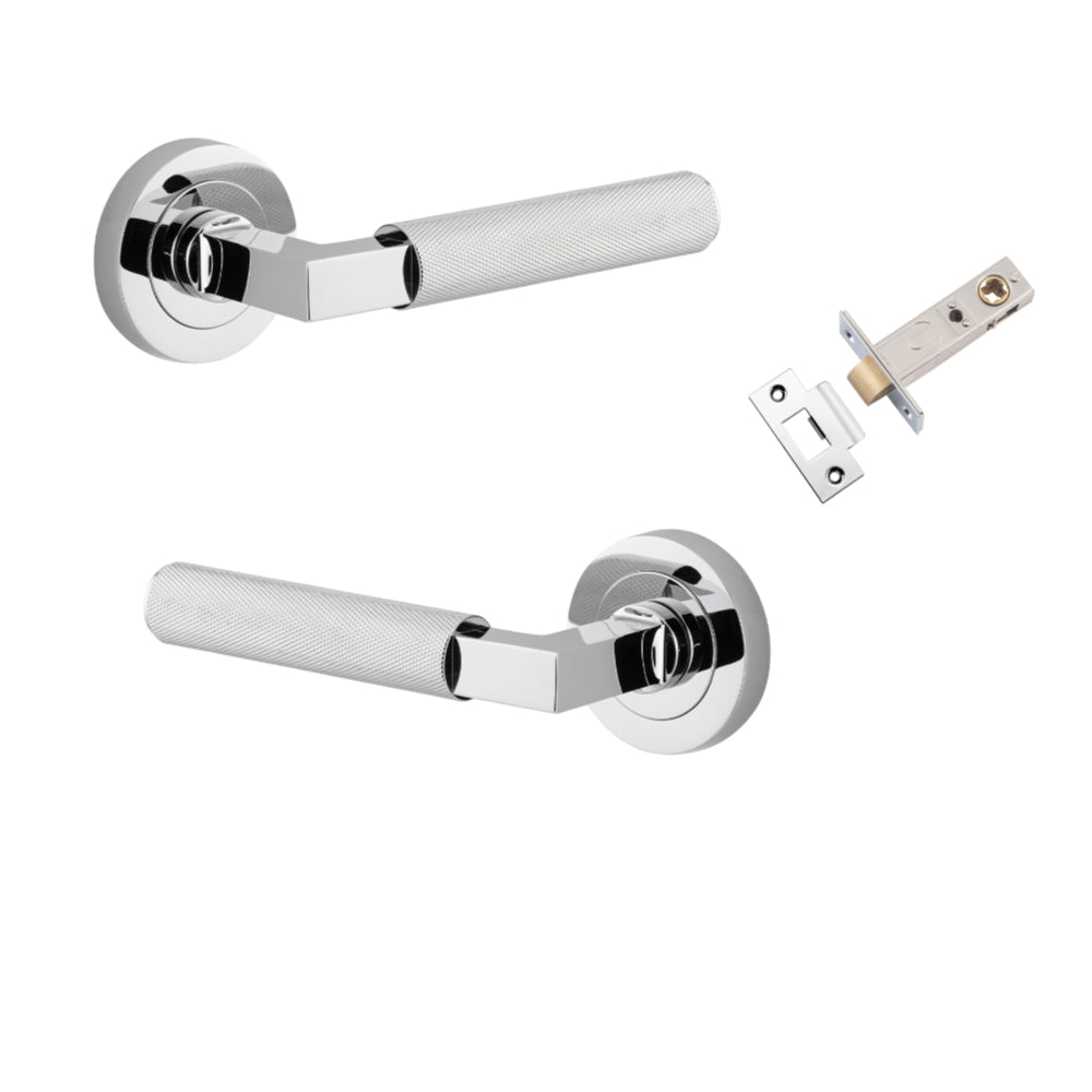 Pair of Iver Brunswick lever handles on round rose plates, architectural hardware with a sleek, modern design for doors.