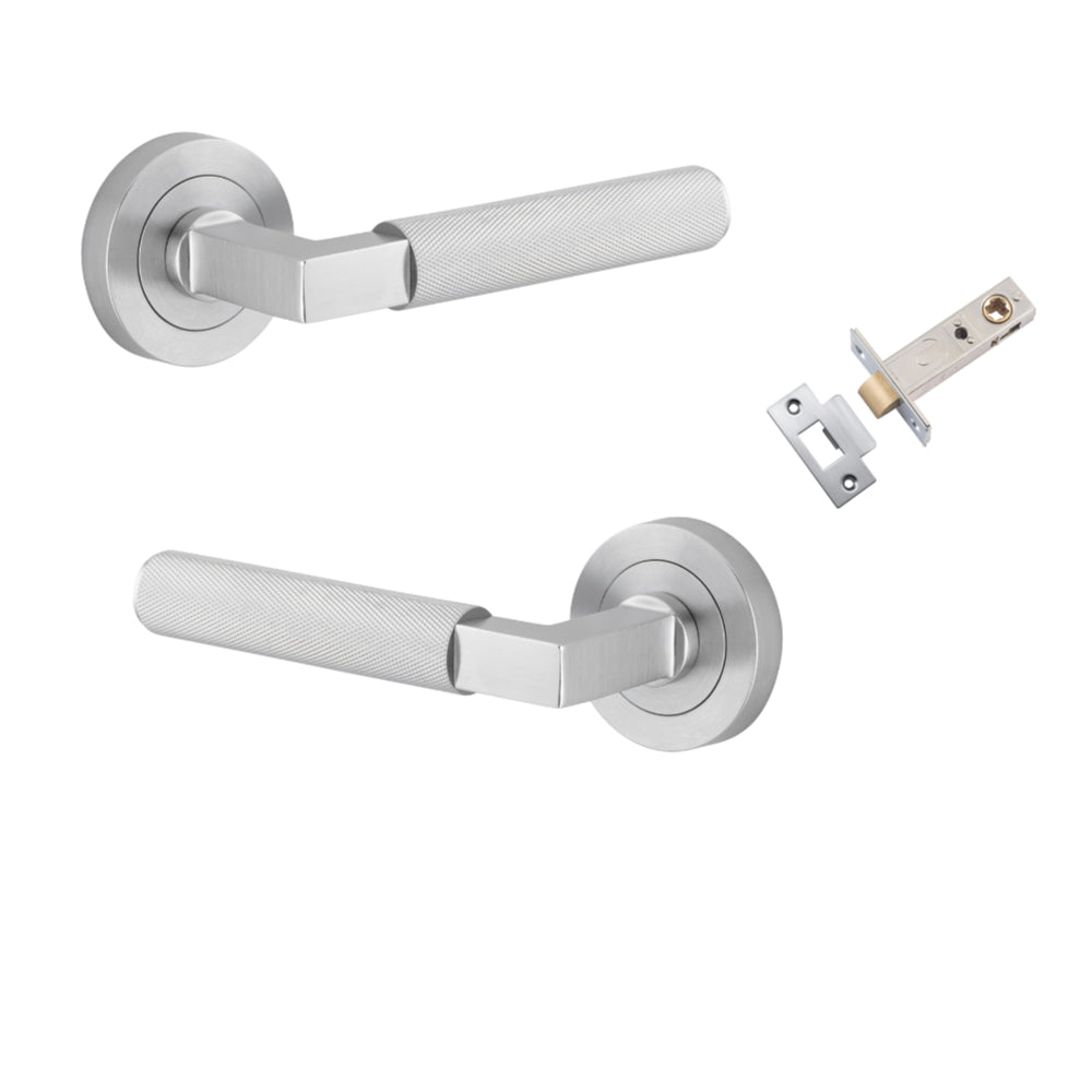Pair of Iver Brunswick lever door handles on round rose, architectural hardware in a sleek, modern design with a polished finish.