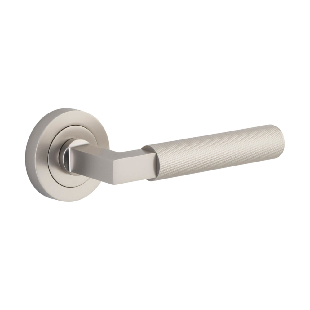 Pair of Iver architectural hardware lever handles on round rose plates, showcasing sleek metal design for doors.