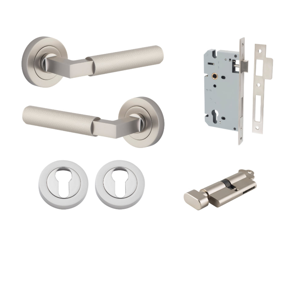 Pair of Iver Brunswick lever handles on round rose, architectural hardware with a sleek, modern design, shown in a close-up image.