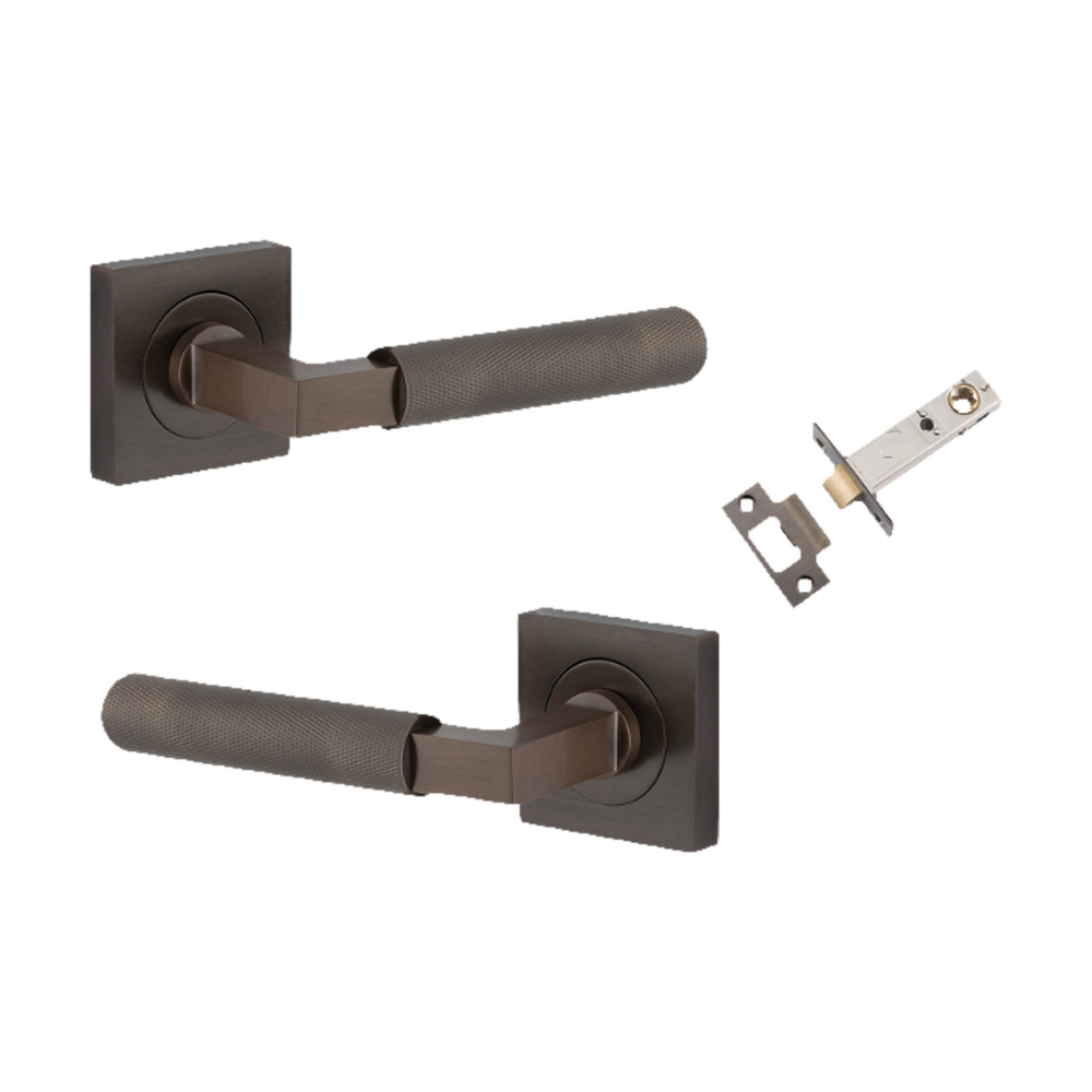 Pair of Iver architectural hardware brass lever handles on square rose for doors, featuring a sleek, modern design.
