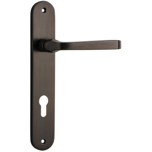 Pair of Iver Annecy lever handles on oval backplates, featuring a sleek modern design for interior door use.
