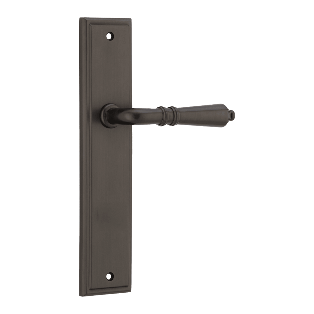Pair of Iver Sarlat lever handles on stepped backplates, showcasing elegant brass finish and classic European design.