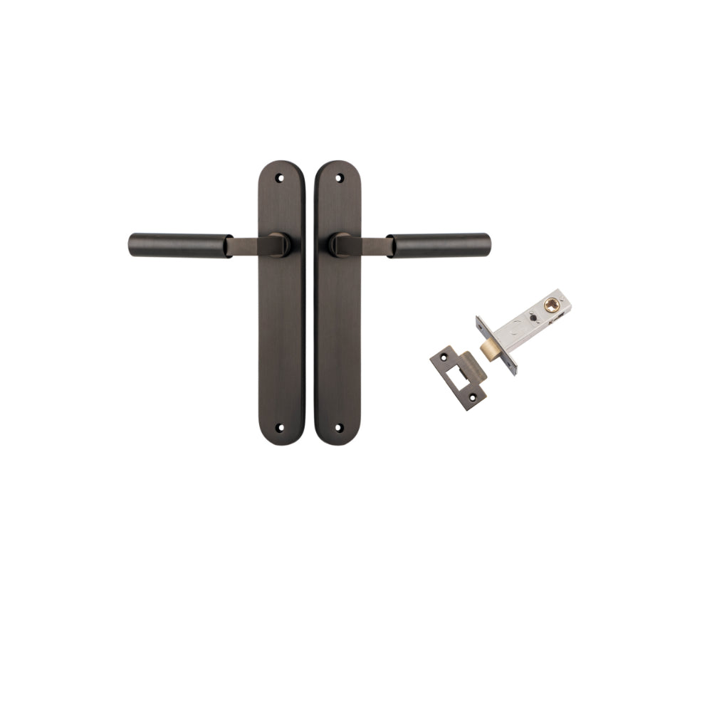 Pair of Iver Berlin lever door handles on oval backplates, showcasing sleek metal finish and modern design for interior doors.