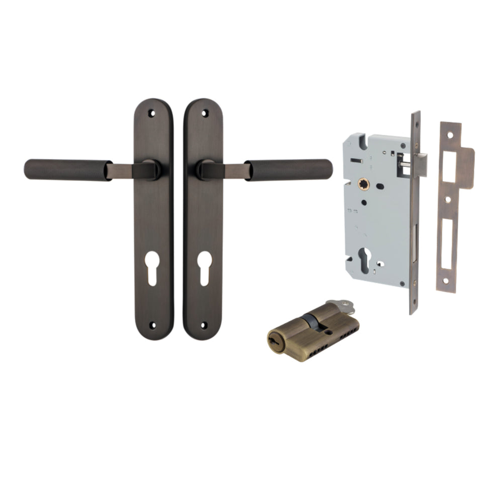 Pair of Iver Brunswick lever handles on oval backplates, architectural hardware with a sleek, modern design.