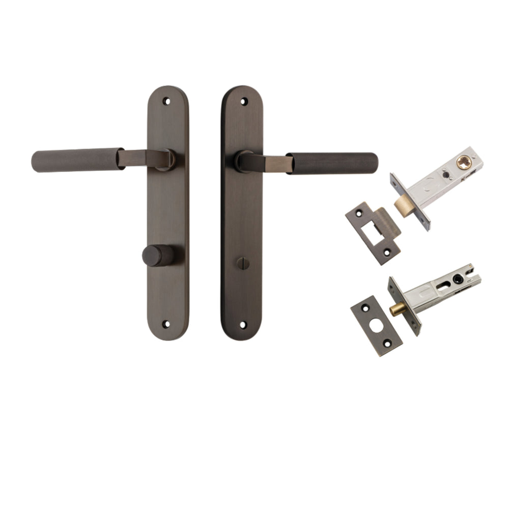 Pair of Iver Brunswick lever handles on oval backplates, architectural hardware with a sleek, modern design.