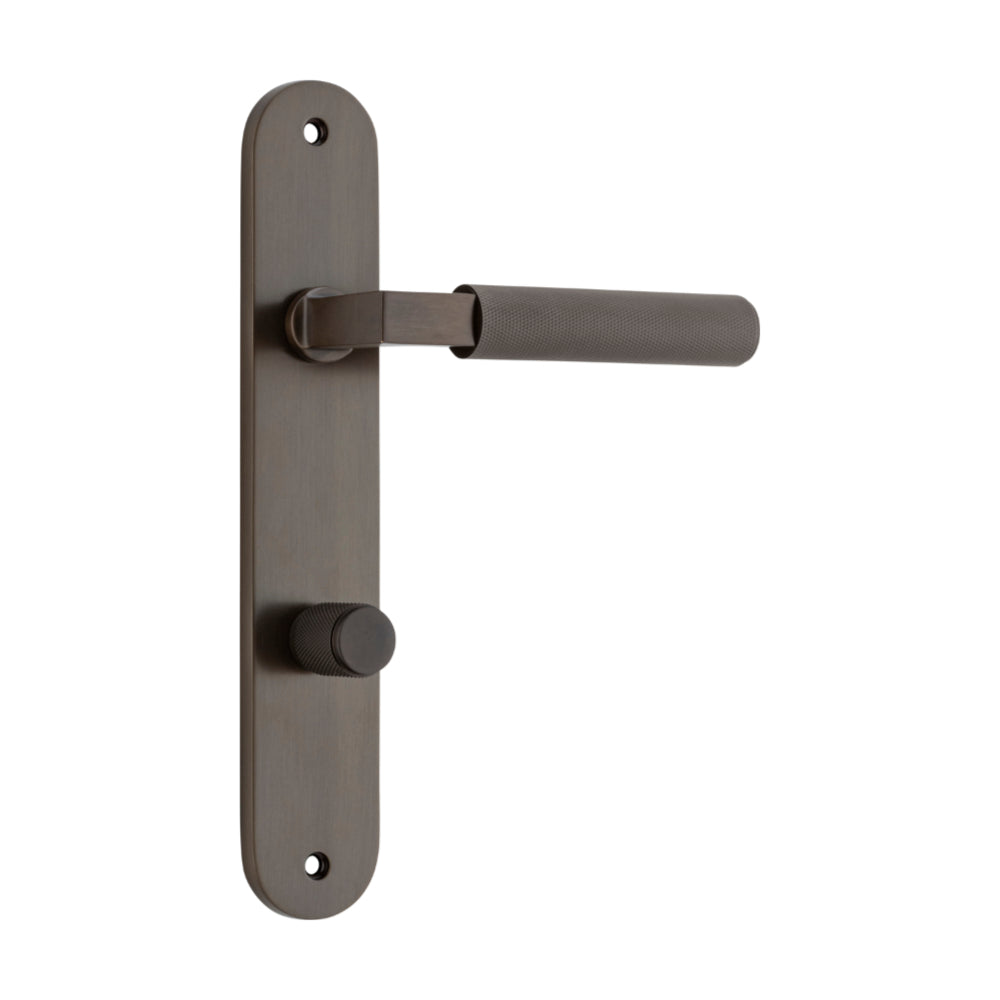 Pair of Iver Brunswick lever handles on oval backplates, architectural hardware, shown in a polished metal finish.