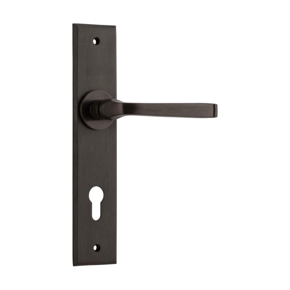 Pair of Iver Annecy lever door handles with chamfered backplates, showcasing elegant, modern design and brushed metal finish.