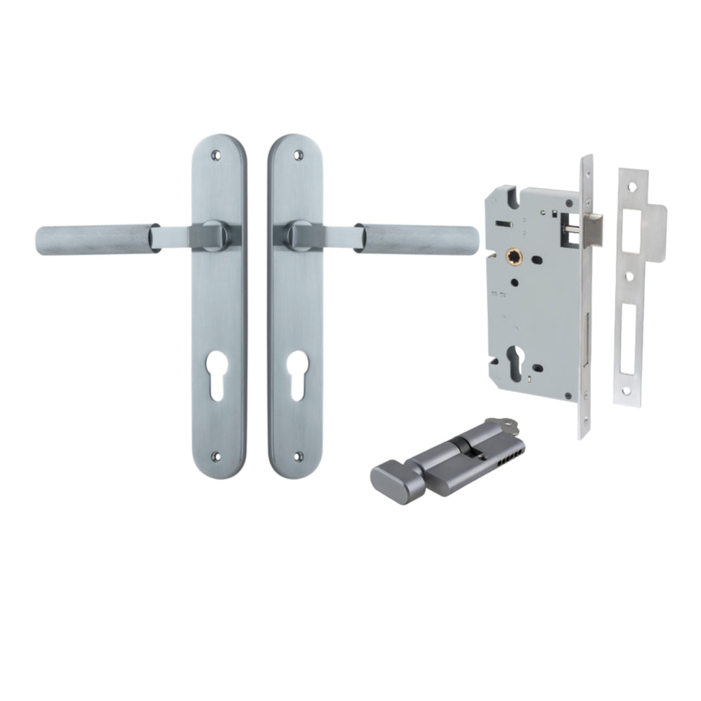 Pair of Iver Brunswick lever handles on oval backplates, showcasing polished brass architectural hardware for doors.