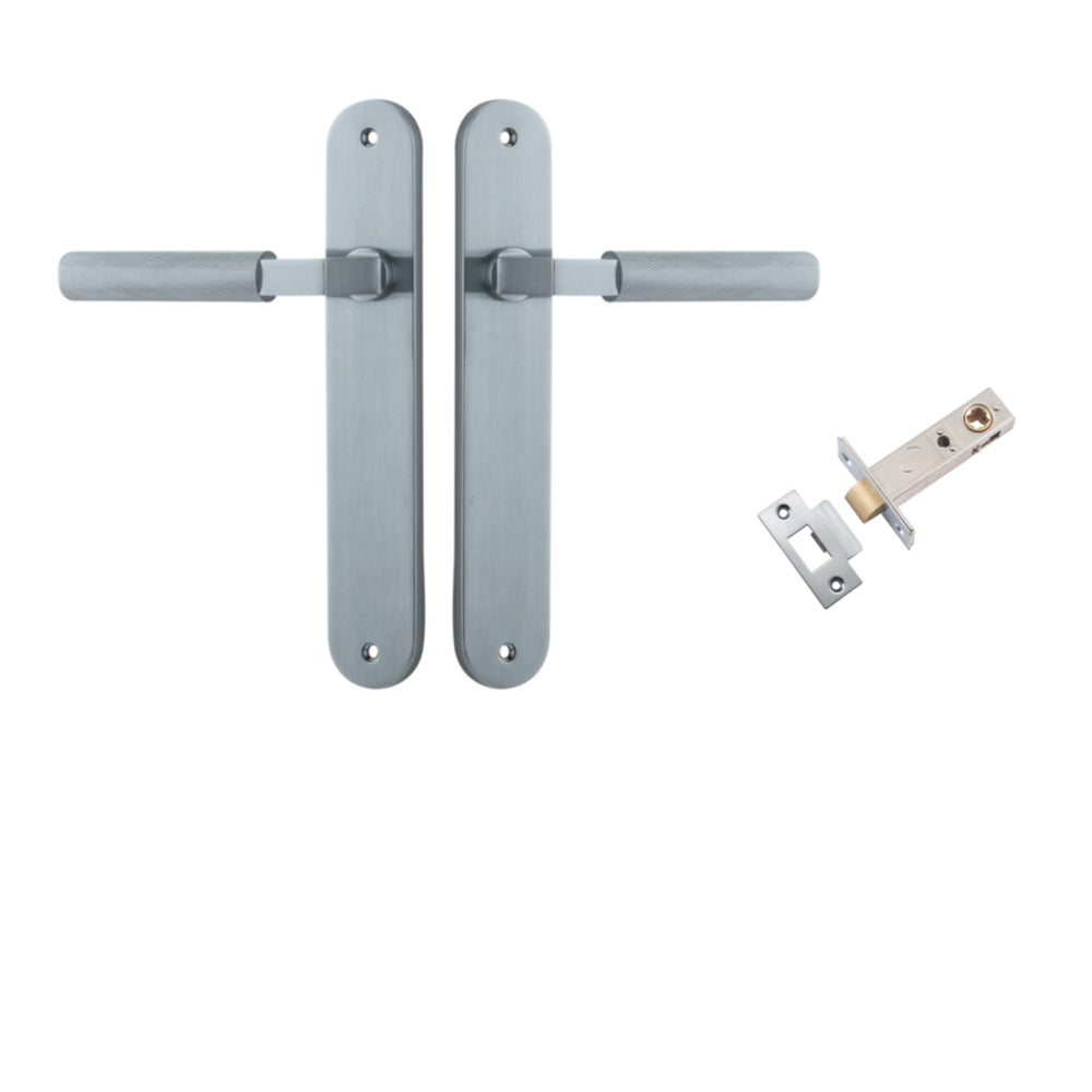 Pair of Iver Brunswick lever handles on oval backplates, architectural hardware for doors, shown in a close-up image.
