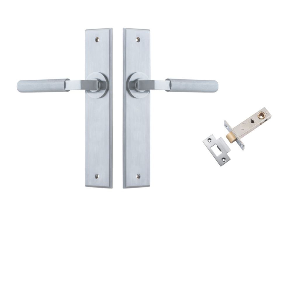 Pair of Iver Brunswick lever handles on chamfered backplates, architectural hardware for doors, shown in a close-up view.