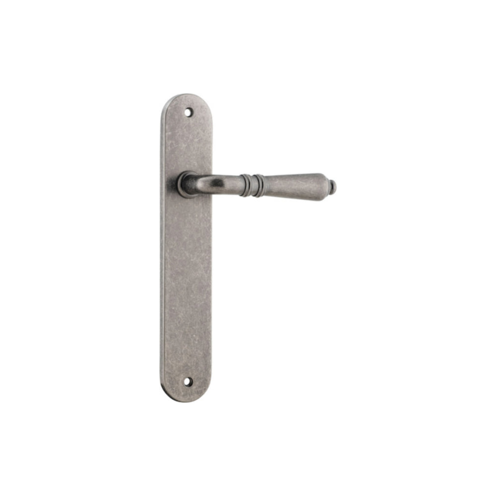 Pair of Iver Sarlat lever handles with oval backplates, showcasing elegant brass finish and classic design for interior doors.