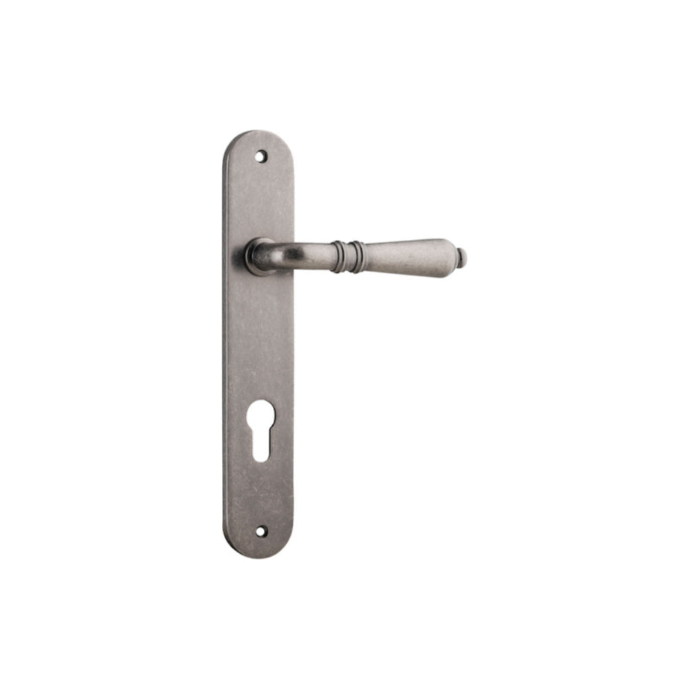 Pair of Iver Sarlat lever handles with oval backplates, showcasing polished metal finish and classic design.