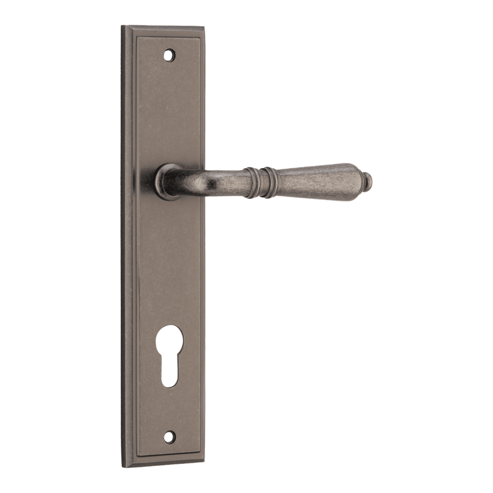 Pair of Iver Sarlat lever handles on stepped backplates, showcasing elegant brushed metal finish and classic door hardware design.