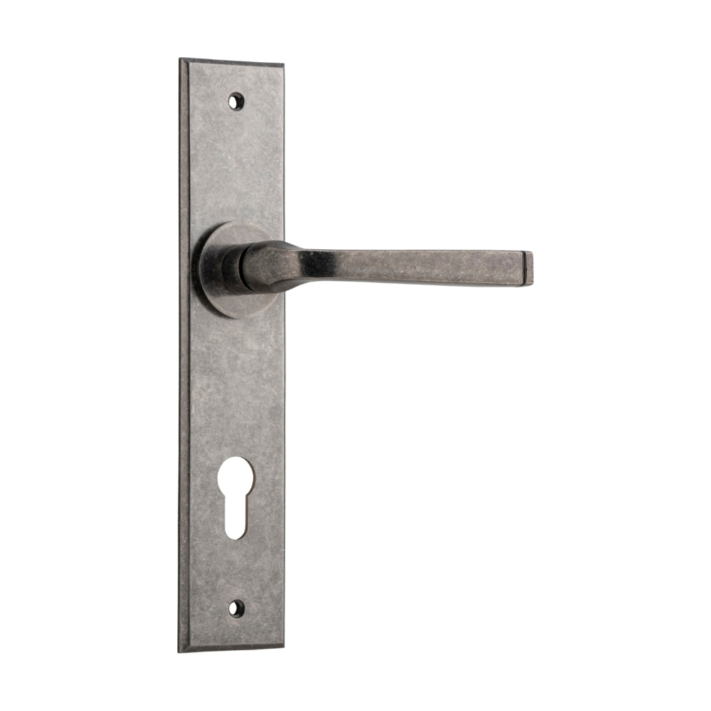 Pair of Iver Annecy lever door handles on chamfered backplates, showcasing elegant brass finish and contemporary design.
