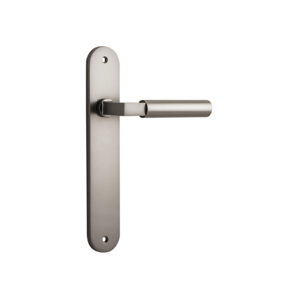 Pair of Iver Berlin lever door handles on oval backplates, showcasing sleek metal design and polished finish.
