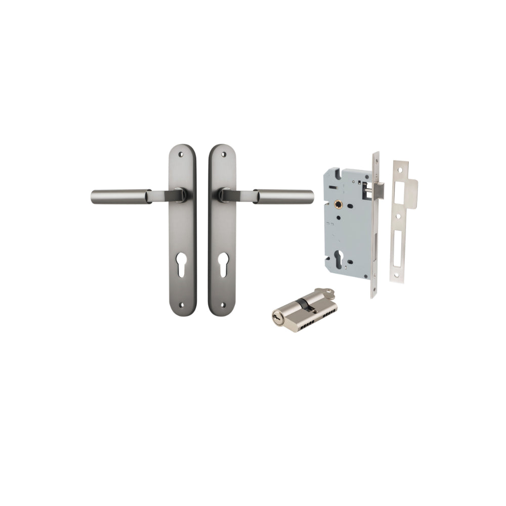 Pair of Iver Berlin lever door handles on oval backplates in a polished finish, mounted on a door.