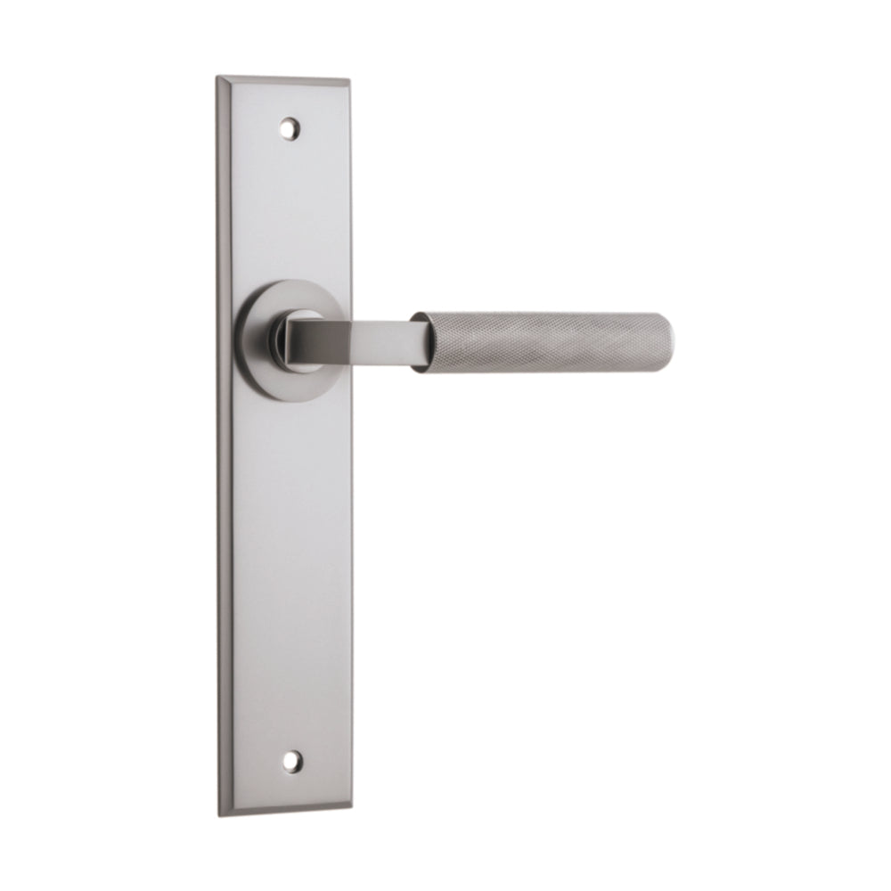 Pair of Iver Brunswick lever door handles on chamfered backplates, architectural hardware for interior doors.