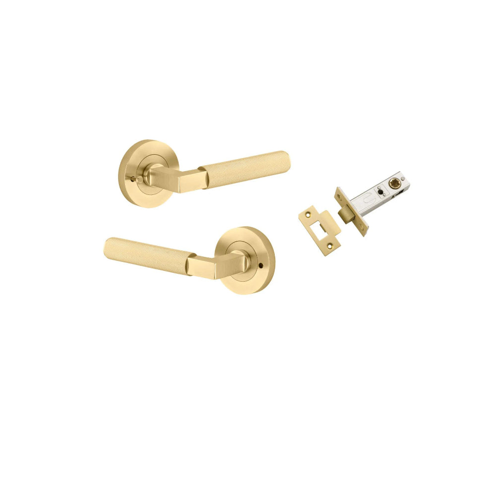 Pair of Iver Brunswick lever door handles on round rose plates, architectural hardware in a sleek, modern design.