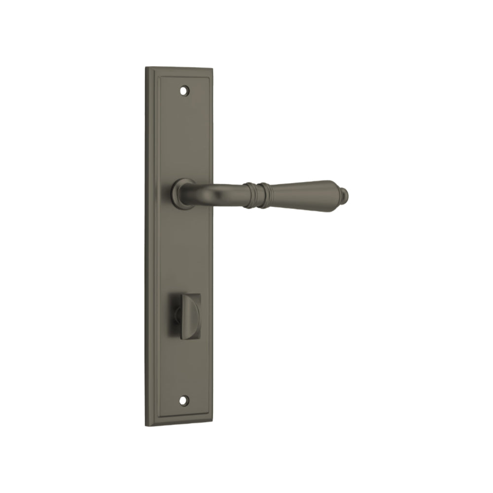 Pair of Iver Sarlat lever handles on stepped backplates, showcasing polished brass finish and elegant design.
