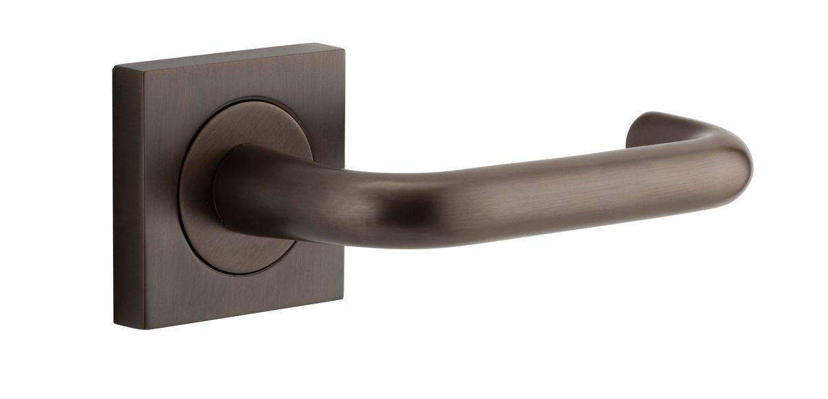Pair of Iver Oslo Lever on Square Rose architectural hardware in a sleek, modern design, featuring polished metal finish.