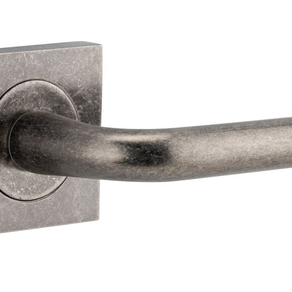 Pair of Iver Oslo Lever on Square Rose architectural hardware, polished metal finish, mounted on square rose plates.