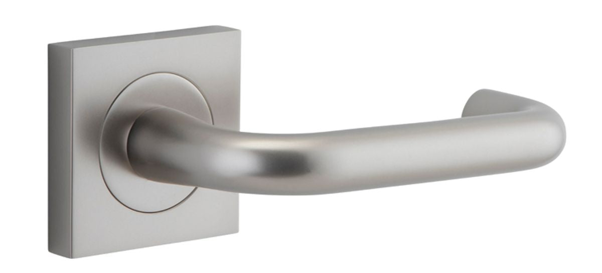 Pair of Iver Oslo Lever on Square Rose architectural hardware, showcasing sleek metal handles with square rose bases.