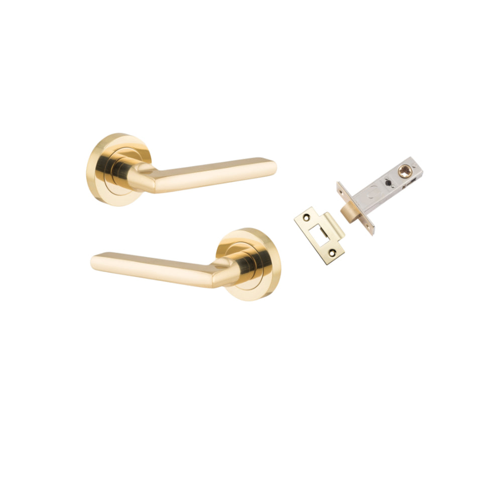 Pair of Iver Baltimore lever door handles on round rose, showcasing brushed brass finish and elegant modern design.