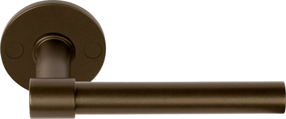 Pair of Formani ONE XL 15Ø lever handles on round rose, showcasing modern brass door hardware design.