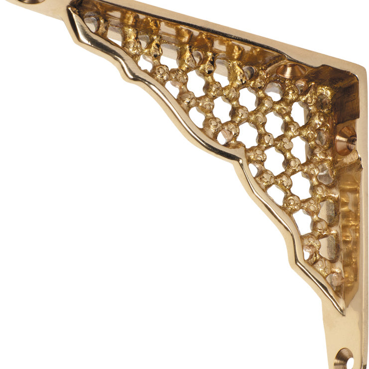 Decorative ornate shelf bracket by Tradco, Southern Design Group, featuring intricate metalwork for supporting shelves in rustic or vintage style.