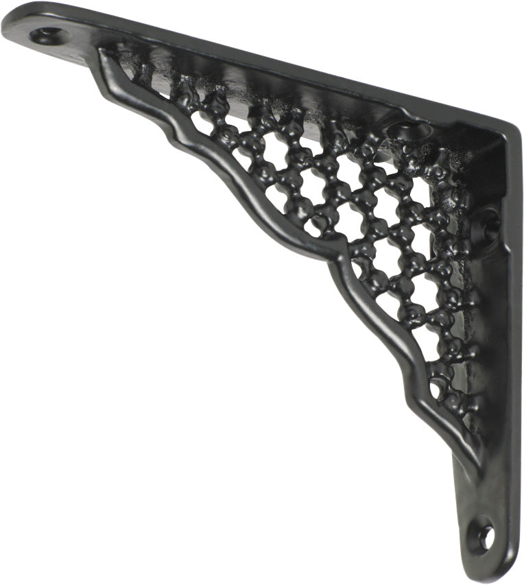 Decorative Tradco ornate shelf bracket in black with intricate scrollwork, mounted on a wooden shelf for support.
