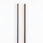 Momo ANGLE cabinet pull handle in matte bronze finish mounted on a wooden cabinet door