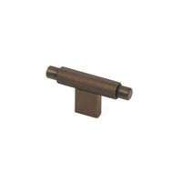 Momo ARPA Cabinet T-Pull handle in brushed metal finish, mounted on a modern cabinet door with visible screw holes.