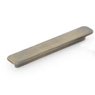 Momo ASPEN cabinet pull handle in dark bronze finish, mounted on a wooden cabinet door, showcasing sleek modern hardware design.