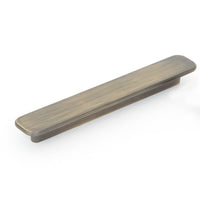 Momo ASPEN cabinet pull handle in dark bronze finish, mounted on a wooden cabinet door, showcasing sleek modern hardware design.
