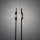 Momo BRAVE Bow off-centred cabinet pull handle in matte black finish mounted on a wooden cabinet door.