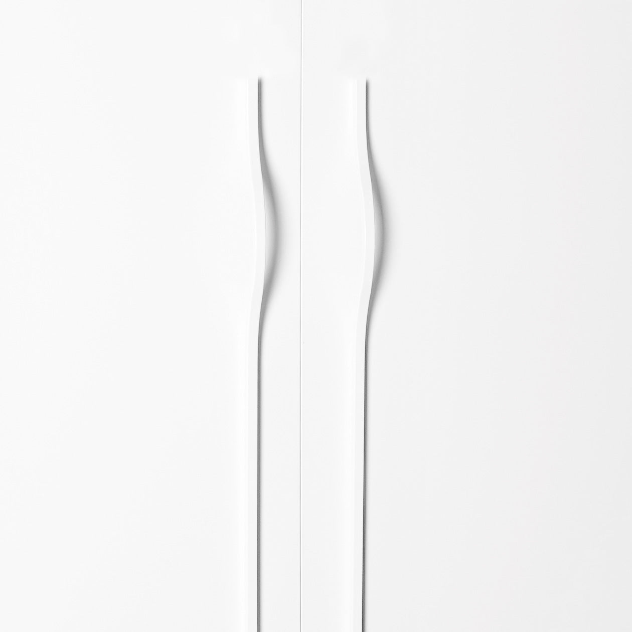 Momo BRAVE Bow off-centred cabinet pull handle in matte white finish, showcasing its sleek, modern design on a cabinet.
