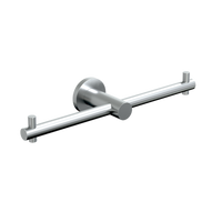 Stainless steel Metlam double toilet paper roll holder mounted on bathroom wall, designed for easy access and durability.