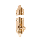 Tradco Victorian barrel bolt in brass, installed on wooden door for secure latch and classic decorative appearance.