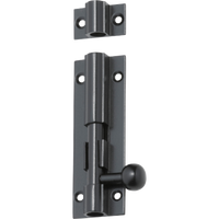Tradco barrel bolt latch with black finish, mounted on a wooden door, for secure door fastening and added security.