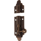 Tradco Victorian barrel bolt installed on a door, featuring a classic brass finish and traditional design for secure fastening.