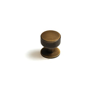 Momo Belgravia knurled cabinet knob in bronze finish, showing textured surface and round shape for modern furniture hardware.