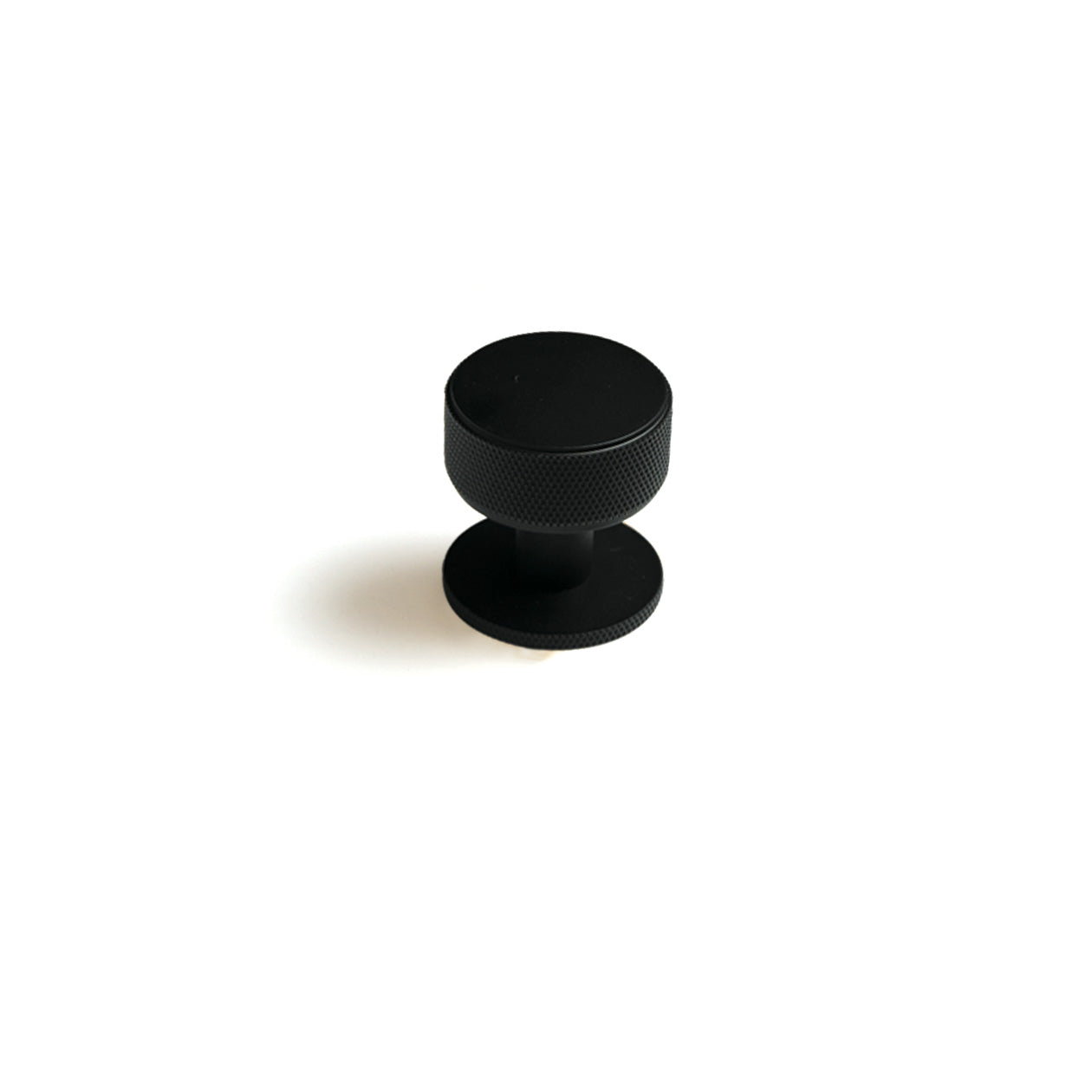 Momo Belgravia Knurled Cabinet Knob with textured metal finish, mounted on a cabinet door for a modern, industrial look.