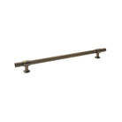 Momo Belgravia lined solid brass appliance pull in dark bronze finish, showing its sleek, curved design on a modern cabinet.