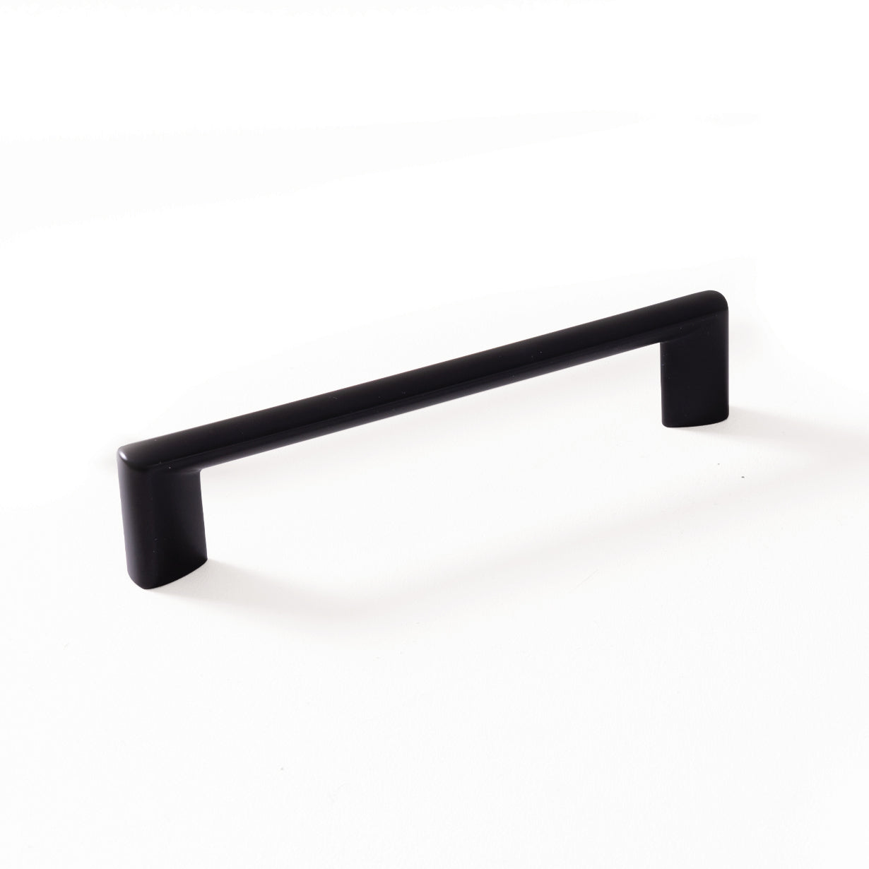 Momo BARRA D cabinet pull handle with a sleek metal finish, mounted on a wooden cabinet door for modern kitchen or furniture decor.